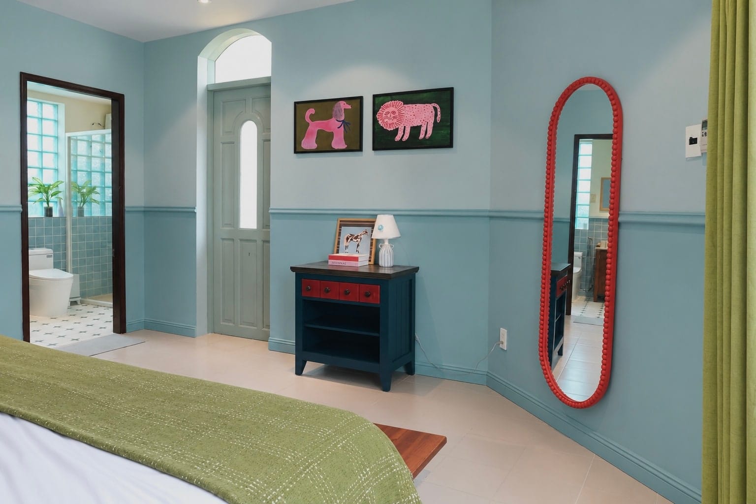 The wall opposite MARE's beds, with bathroom doorway, cabinet and coral mirror